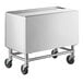 A stainless steel rectangular ice bin with black wheels.