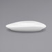 A white Front of the House Tides oval porcelain plate on a gray surface.