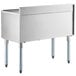 A Regency stainless steel underbar ice bin with sliding lid and bottle holders on a white counter.