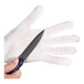 A person wearing a San Jamar cut-resistant glove using a knife.
