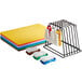 A rack with brushes and six colorful plastic cutting boards.