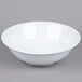 A white GET SuperMel melamine bowl on a gray surface.