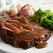 A plate of meat with Vanee roasted beef gravy and broccoli.