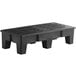 A black plastic bench with slotted top.