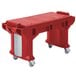 A red plastic Cambro Versa work table on standard casters.