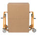 A carton of cardboard boxes on a Wesco hand truck with two wheels.