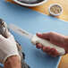 A person using a Dexter-Russell slimming knife to fillet a fish.