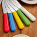 A group of Dexter-Russell sandwich spreaders with colorful handles.