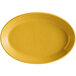 A yellow oval Tuxton china platter with a rim.