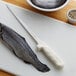 A Dexter-Russell Sani-Safe Fillet Knife cutting a fish.