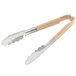 A pair of Vollrath stainless steel tongs with tan Kool Touch handles.