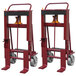 Two red Wesco Industrial Products machinery movers with steel casters.
