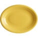A yellow oval Acopa Capri stoneware platter with a rim.