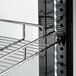 A metal shelf with a wire rack on it inside an Avantco Copper Glass Door Refrigerated Display Case.