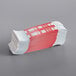 A stack of red and white paper currency straps.