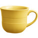A close-up of a yellow Acopa Capri stoneware coffee cup with a handle.