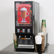 A black Bunn hot beverage dispenser with 3 hoppers.