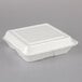 A Dart white styrofoam 3 compartment hinged lid container.