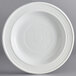 An Acopa Capri coconut white stoneware plate with a spiral pattern.