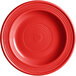 A red Acopa Capri stoneware plate with a spiral pattern.