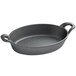 A black oval cast iron casserole dish with two handles.