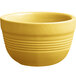 An Acopa Capri citrus yellow stoneware bouillon bowl with a handle.