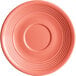 An Acopa Capri stoneware saucer in coral with a ruffled edge and a circular pattern.