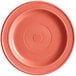 A close-up of an Acopa Capri coral stoneware plate with a red circle in the middle.