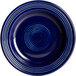 An Acopa Capri Deep Sea Cobalt stoneware plate with blue lines in a spiral design.