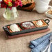 A Valor pre-seasoned cast iron tray with three desserts on it.