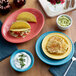 A table set with Acopa Capri citrus yellow stoneware plates of tacos and eggs.