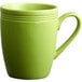 An Acopa Capri green stoneware mug with a handle.