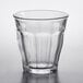 A Duralex Picardie clear glass tumbler on a white background with a curved edge.