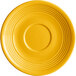 A mango orange stoneware saucer with a rim and circular pattern.