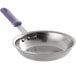 A Vollrath stainless steel frying pan with a purple allergen-free sleeve handle.