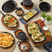 A Valor cast iron fajita skillet on a table with various dishes.