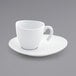 A close up of a white Front of the House Ellipse cup on a saucer.