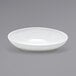 A Front of the House white oval porcelain bowl on a gray background.