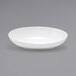 A Front of the House white porcelain oval bowl on a gray surface.
