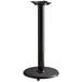 A black Lancaster Table & Seating cast iron table stand with a round base.