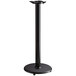 A black metal Lancaster Table & Seating bar height table base with a round base.