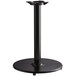 A black Lancaster Table & Seating cast iron table base with a round stand.