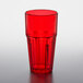 A red plastic tumbler on a white surface.