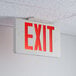 A Lavex Slim LED exit sign hanging from a ceiling.