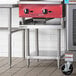 A stainless steel Regency equipment stand with a stainless steel undershelf.