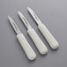 Three Dexter-Russell Sani-Safe paring knives with white handles.