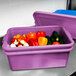 A purple Vollrath Color-Mate food storage container filled with vegetables.