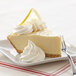 A slice of Rich's On Top lemon pie with whipped topping on a plate.