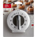 A Taylor 5831N mechanical kitchen timer in white packaging with black numbers.