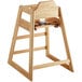 A Lancaster Table & Seating wooden high chair with a natural finish, seat, back, and strap.